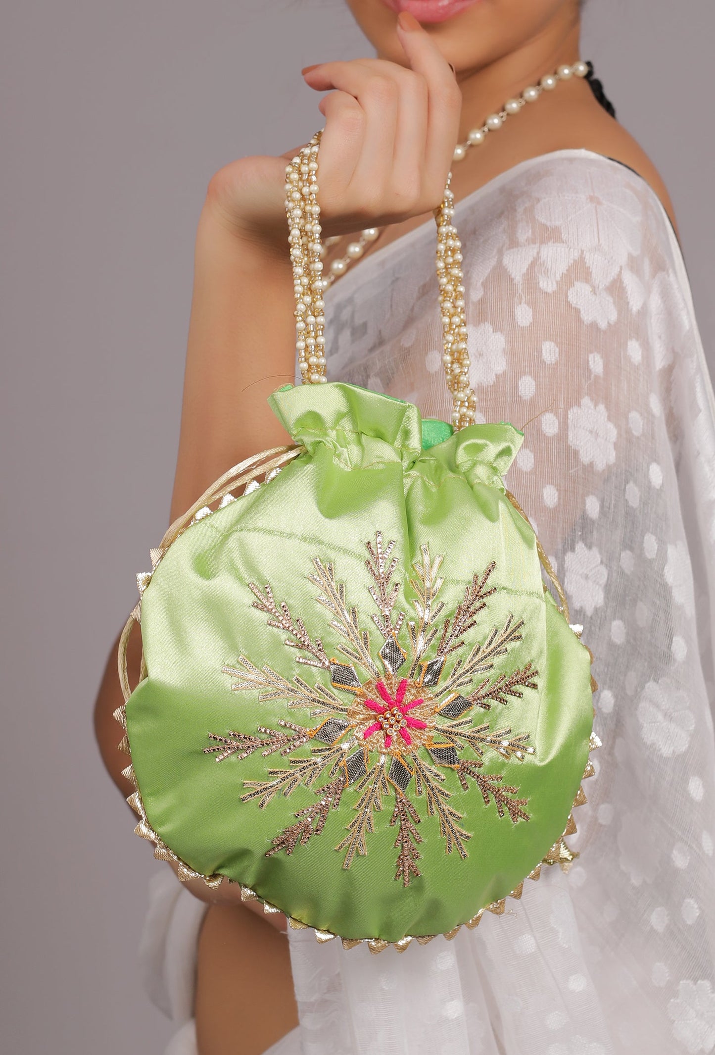 The Fernista Scarlet Potli in Parrot Green
